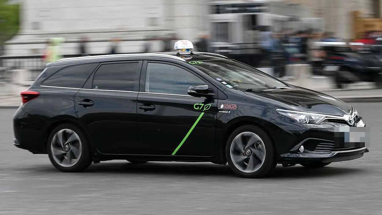 Toyota Corolla taxi in traffic, seen from the front